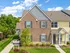 Spring Haven| Fresh green grass around the sidewalk leading up to individual entryway awning. Two story buildings connected to each other.
