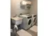Laundry room, a washer and dryer next to each other. There is a single shelf above the appliances. A sink next to the washer and dryers as well
