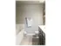 Garden style white tubs. Light grey paint with a towel rack next to the tub. Light grey hard wood flooring