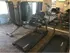 Work out room side view of the treadmills in front of the mirror. There is a sliding door on the side of the room w