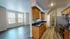 Inviting apartment interior featuring a modern kitchen with sleek granite countertops, warm wooden cabinetry, and an open-concept living area with abundant natural light.