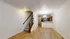 Charming open-concept living area with elegant hardwood floors, inviting staircase, and a modern kitchen with stylish cabinetry.