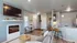 Modern open-concept living space featuring a cozy fireplace, elegant breakfast bar, and chic decor, perfect for entertaining and relaxation.
