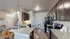 Contemporary kitchen with granite countertops, modern appliances, and stylish dark wood cabinets.