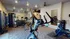 Modern apartment gym with state-of-the-art equipment, including ellipticals, weights, and exercise bikes, set in a spacious and well-lit room.