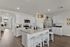Modern kitchen with island seating, granite countertops, and stainless steel appliances.