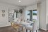 Stylish dining area with natural light and patio access.