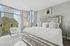 Bedroom with floor-to-ceiling windows and city views