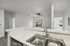 interior pic of deluxe kitchen unit with gray planking and white walls, stainless steel appliances and backsplash