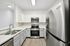 interior pic of deluxe kitchen unit with gray planking and white walls, stainless steel appliances and backsplash