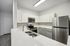 interior pic of deluxe kitchen unit with gray planking and white walls, stainless steel appliances and backsplash