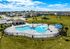 Resort-style pool with splash feature, cabana, and plenty of room to unwind.
