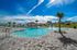 Expansive community pool with splash features and open-air seating.