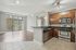 Open-concept kitchen with stainless steel appliances and bar counter