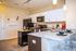 Contemporary kitchen with granite countertops, sleek cabinetry, and modern appliances.