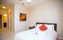 Spacious bedroom with en-suite access and ample closet space.