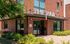 Main entrance to The Pad apartment community with red brick exterior and modern signage.