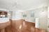 Bright and spacious open-concept living area with modern kitchen, featuring sleek hardwood floors and abundant natural light.