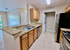 Modern kitchen with granite countertops, stainless steel appliances, and in-unit laundry for convenient living.