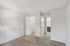 Bright and spacious bedroom with plush carpeting, featuring a walk-in closet and an adjoining bathroom with modern fixtures.