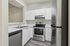 Modern kitchen with sleek stainless steel appliances, elegant white cabinetry, and polished countertops.