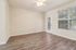 Bright and airy room with sleek hardwood floors, a ceiling fan, and large windows offering scenic views.