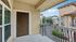 Inviting apartment entrance with elegant wrought-iron railing and charming neighborhood view.