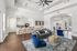 Spacious open-concept living area with modern kitchen, elegant seating, and bright natural light.