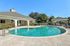 A sparkling pool, sun loungers, and a charming patio area, perfect for relaxation and recreation.