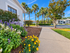 Landscaped walkway beside updated apartment buildings at Willow Lake Crossing.