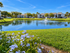 Pond and fountain at Willow Lake Crossing with palms and updated apartment buildings beyond.