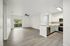 interior pic of deluxe kitchen unit with gray planking and white walls, stainless steel appliances and backsplash