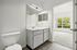 interior pic of deluxe unit bathroom with gray planking, floating vanity, LED lighting and white walls