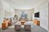Virtually staged living room with modern gray furniture and large windows.
