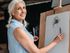 woman drawing on an easel