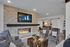Resident lounge at our senior living community in Denver, CO, featuring cushioned chairs and a fireplace.