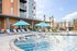 swimming pool with sun deck and lounge chairs
