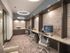 Offices at our senior living community in Flower Mound, TX, featuring carpeted flooring and a long desk with computers.