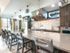 Resident lounge at our senior living community in Flower Mound, TX, featuring counter seating and a full kitchen.