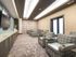 Theater room at our senior living community in Flower Mound, TX, featuring cushioned chairs in front of a flat screen TV.