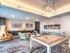 Entertainment lounge at our senior living community in Flower Mound, TX, featuring carpeted flooring and a billiards table.