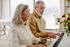 55+ man and woman playing the piano