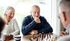 55+ man and woman playing chess