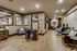 Inviting salon interior featuring elegant wood paneling, plush seating, contemporary artwork, and stylish grooming stations under soft ambient lighting.