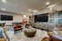 Luxurious entertainment room with cozy leather chairs, elegant wooden cabinetry, and a spacious TV area for ultimate relaxation.