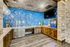 Chic kitchen space with stunning blue subway tiles, rustic wooden cabinets, and sleek modern appliances for a stylish and functional look.