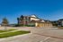 Elegant modern apartment complex with spacious garages and well-maintained surroundings under a clear blue sky.