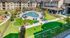 Luxurious apartment complex with stunning courtyard view, featuring a sparkling pool, green spaces, and modern amenities.