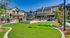 Luxurious apartment complex with lush landscaping, a sparkling pool, and cozy outdoor seating areas for relaxation.