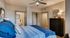 Inviting bedroom with plush bedding, ample natural light, and modern decor for ultimate comfort.